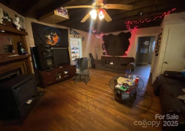 298 Speedwell Road Cullowhee, NC 28723 - Photo 2 of 20 a living room with furniture a flat screen tv and a fireplace