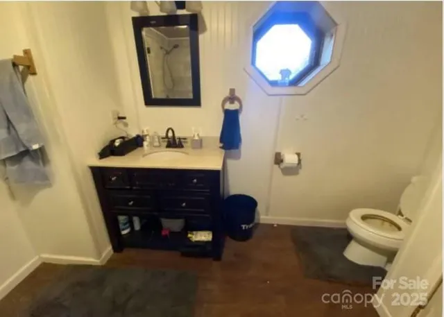 a bathroom with a toilet a sink and a mirror