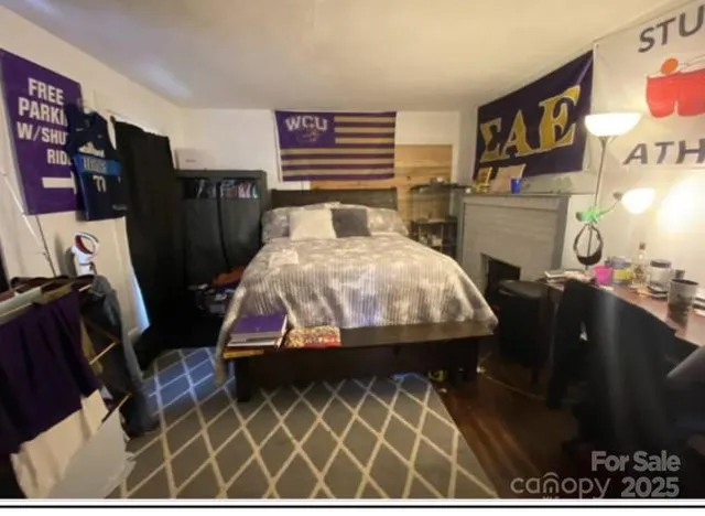 a bedroom with furniture and wooden floor
