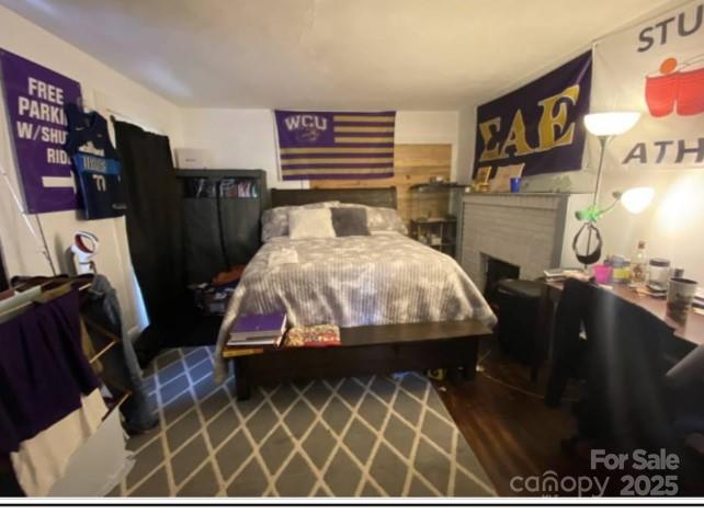 298 Speedwell Road Cullowhee, NC 28723 - Photo 9 of 20 a bedroom with furniture and wooden floor