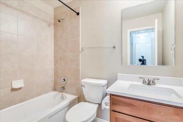 a bathroom with a sink toilet vanity and shower