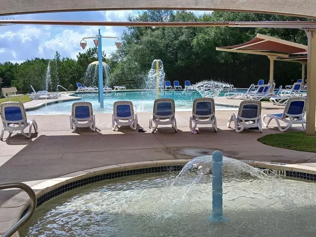 a view of a patio with table and chairs under an umbrella