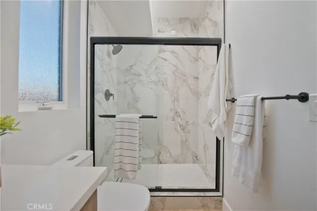 a bathroom with a shower and a toilet