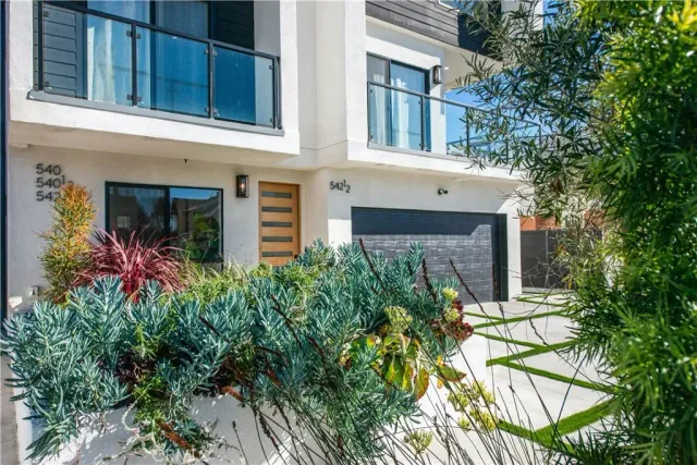 a view of a house with brick walls and a flower garden