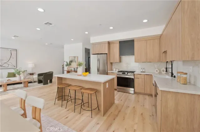 a kitchen with a sink a stove a refrigerator and cabinets