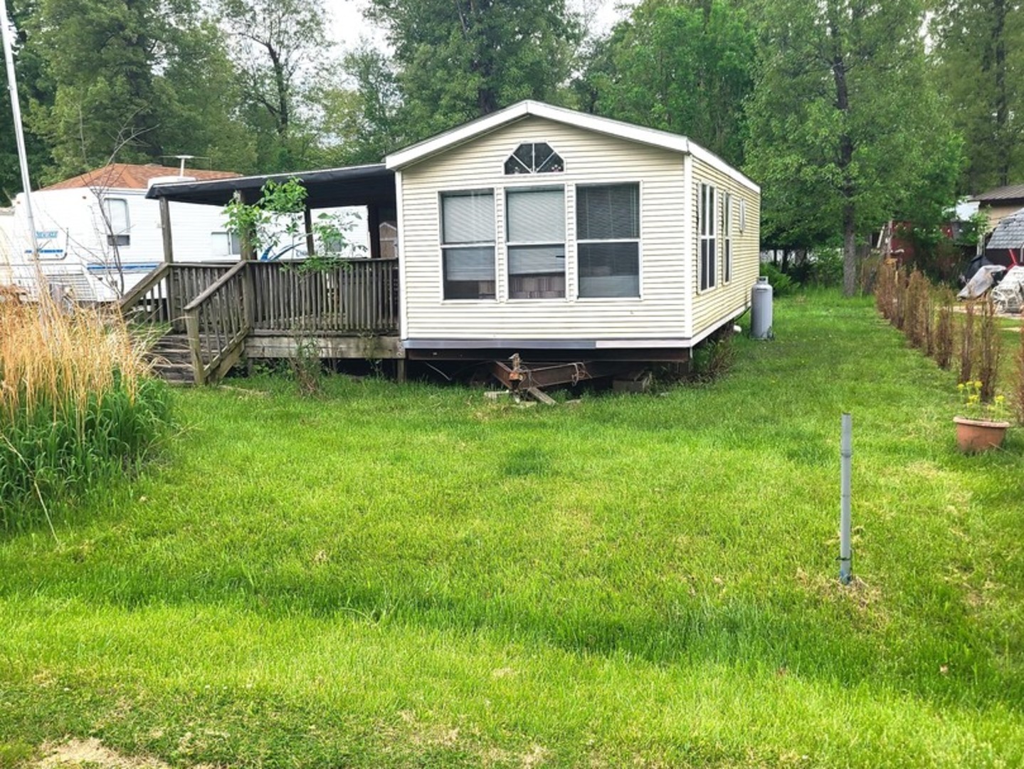 4-213 Woodhaven Sublette, IL 61367 - Photo 2 of 12 a view of a wooden house with a yard
