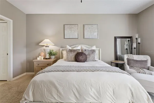 a bedroom with a bed and a lamp