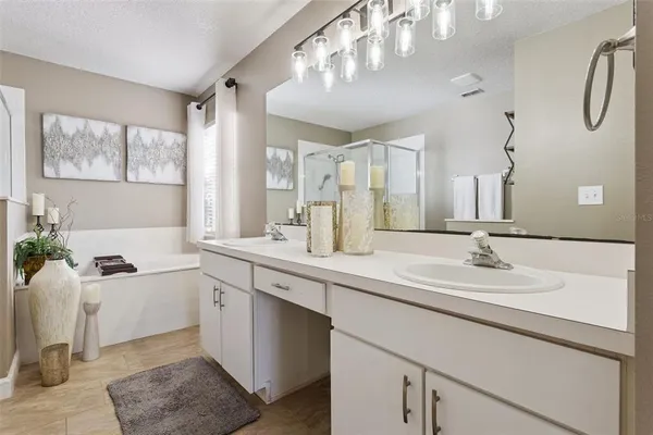 a bathroom with a sink double vanity granite and a mirror