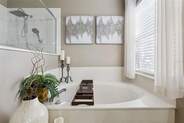 a white bath tub sitting next to a window