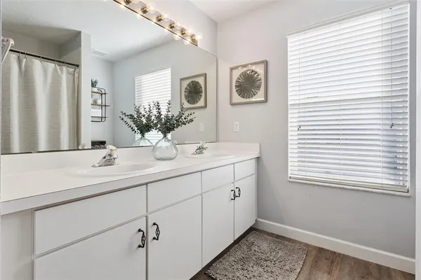 a bathroom with a double vanity sink and a mirror