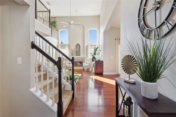 a view of entryway and hall with wooden floor