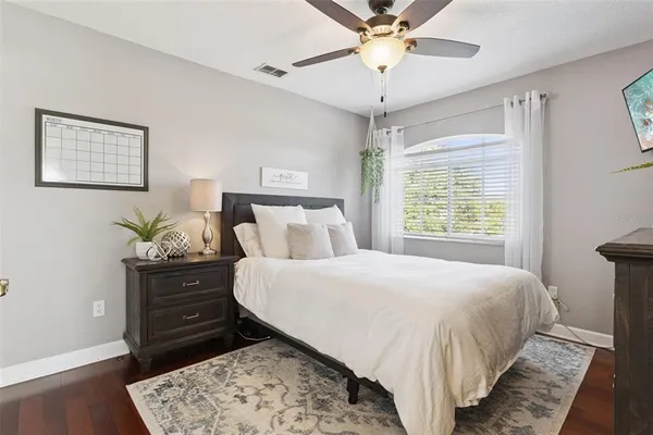 a bedroom with a large bed and a chandelier