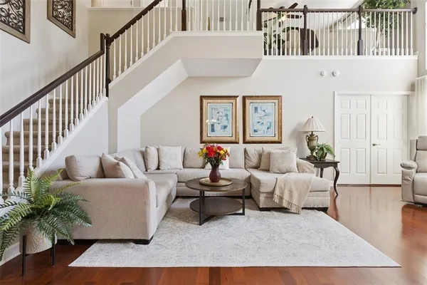 a living room with furniture and wooden floor