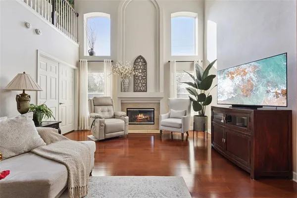 a living room with furniture a fireplace and a flat screen tv