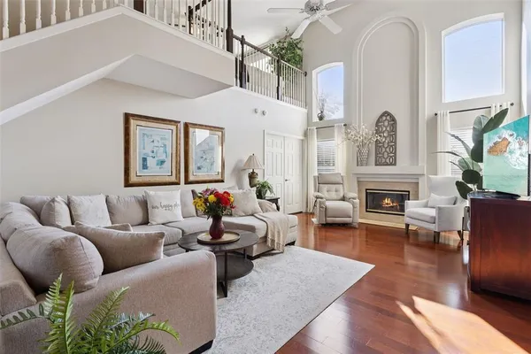 a living room with furniture fireplace and a large window