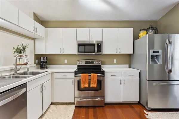 a kitchen with a refrigerator stove and sink