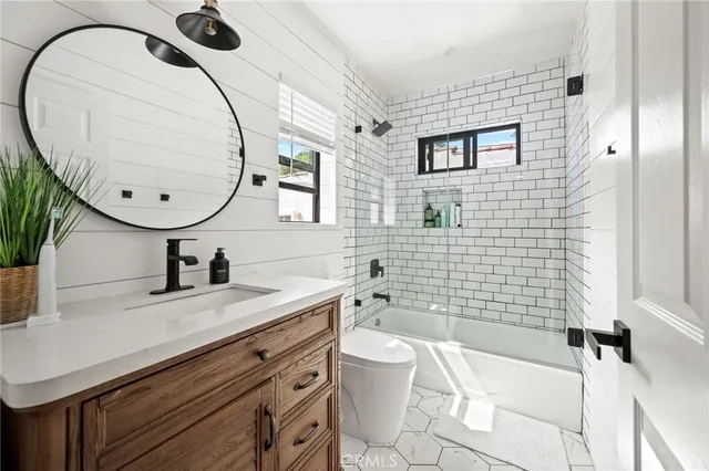 a bathroom with a sink a toilet and mirror
