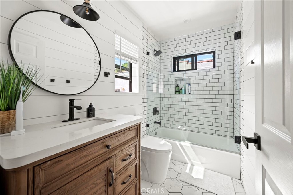 3345 Oakhurst Avenue Los Angeles, CA 90034 - Photo 12 of 49 a bathroom with a sink a toilet and mirror