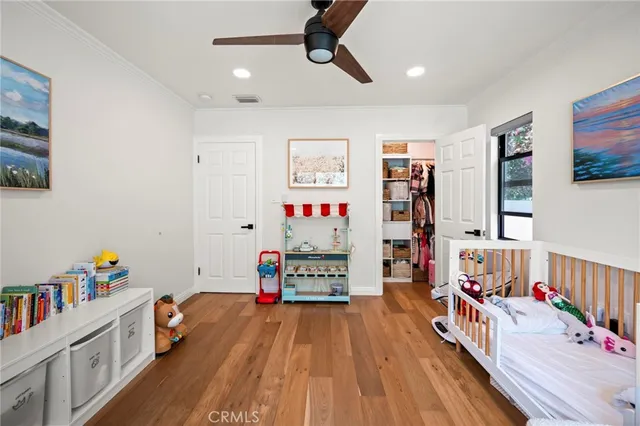 a bedroom with furniture and a book shelf