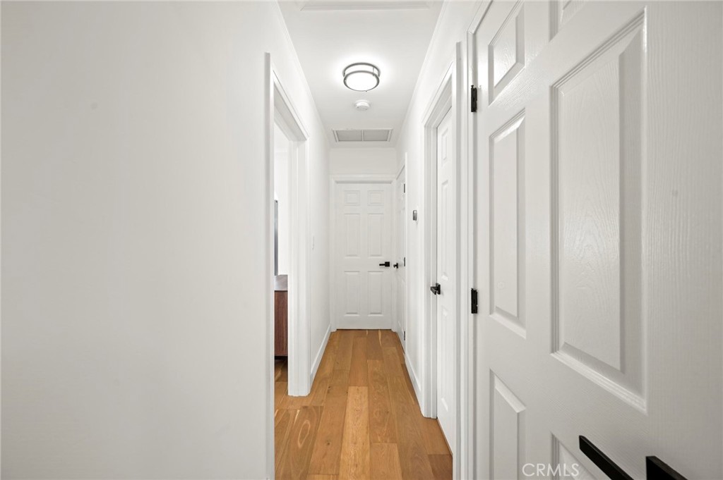 3345 Oakhurst Avenue Los Angeles, CA 90034 - Photo 16 of 49 a view of a hallway with wooden floor and staircase