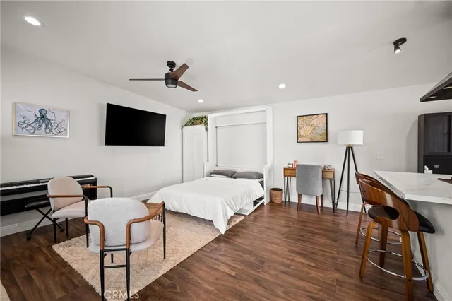 a view of a livingroom with furniture and a flat screen tv