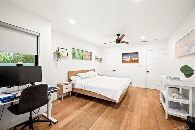 a bedroom with a bed and a flat screen tv