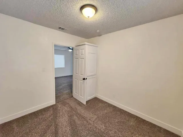 a front view of a house with a garden and trees