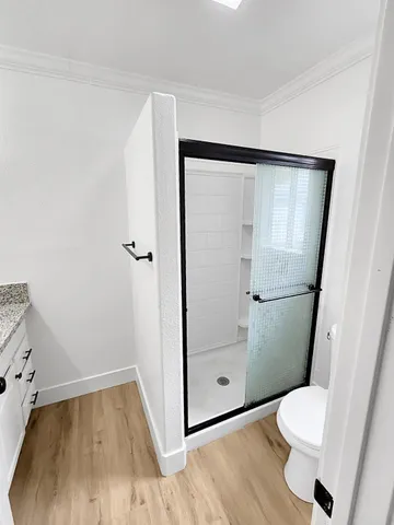 a bathroom with a toilet and a shower