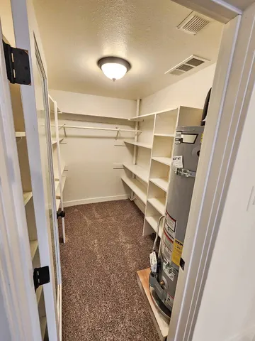 an empty room with closet and mirror