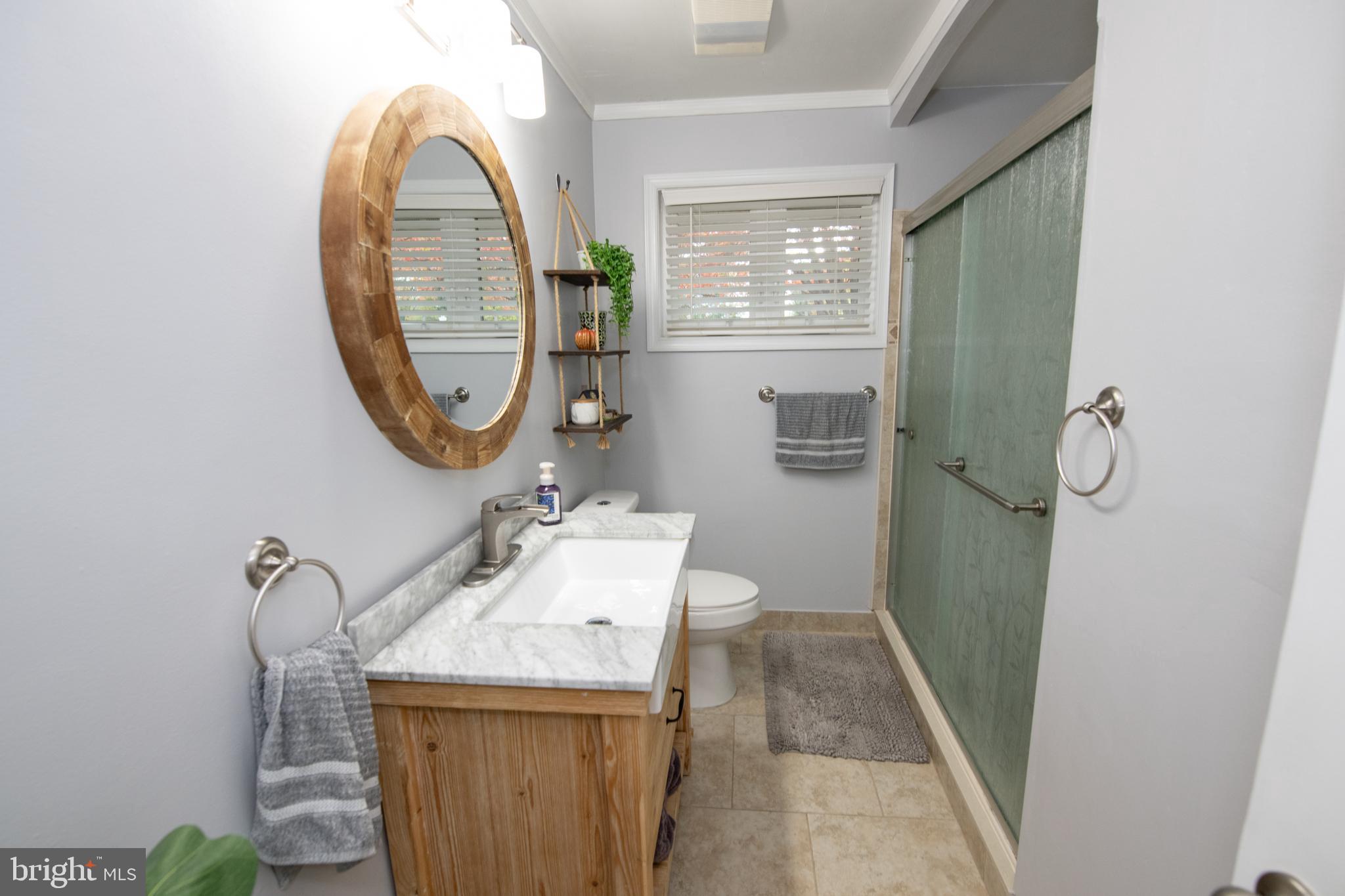 1309 Clyde Road Warminster, PA 18974 - Photo 25 of 39 a bathroom with a sink a toilet and a mirror