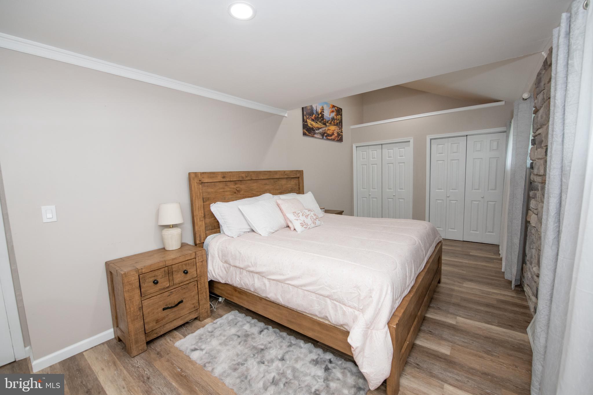1309 Clyde Road Warminster, PA 18974 - Photo 28 of 39 a bedroom with a bed and wooden floor