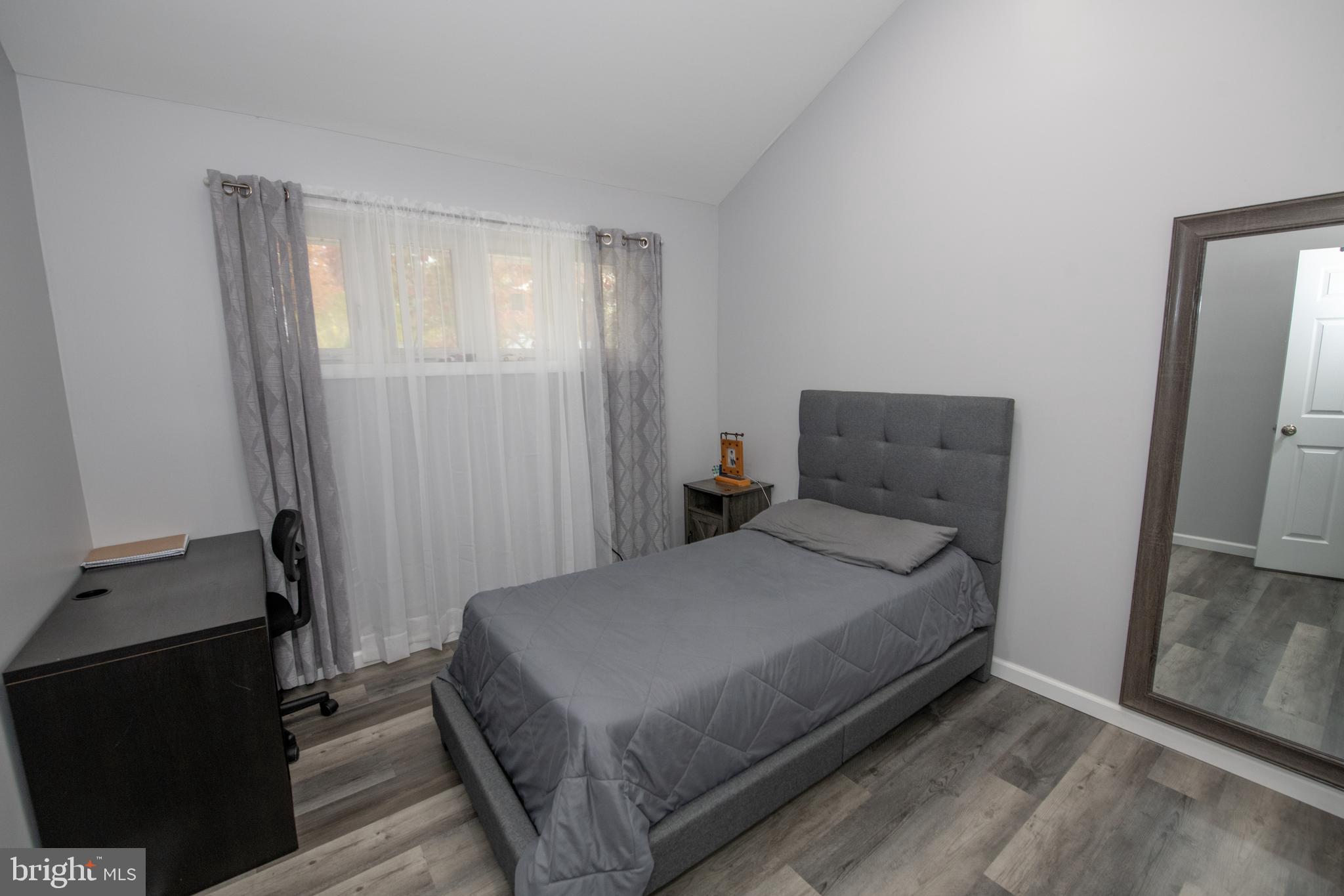 1309 Clyde Road Warminster, PA 18974 - Photo 34 of 39 a bedroom with a bed and a mirror