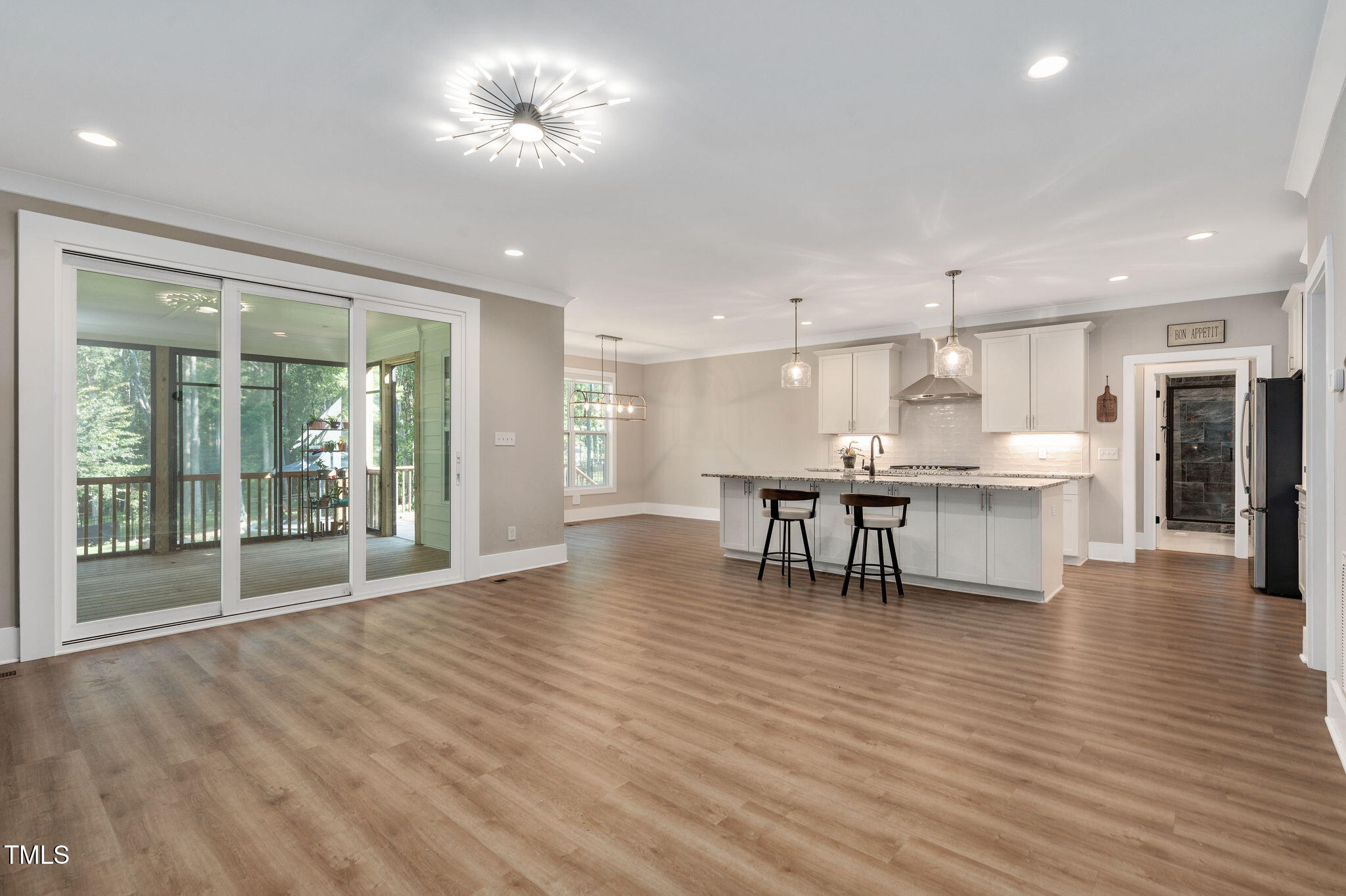 3511 Bruce Garner Road Wake Forest, NC 27587 - Photo 11 of 46 a view of a kitchen with a dining table chairs and floor to ceiling window