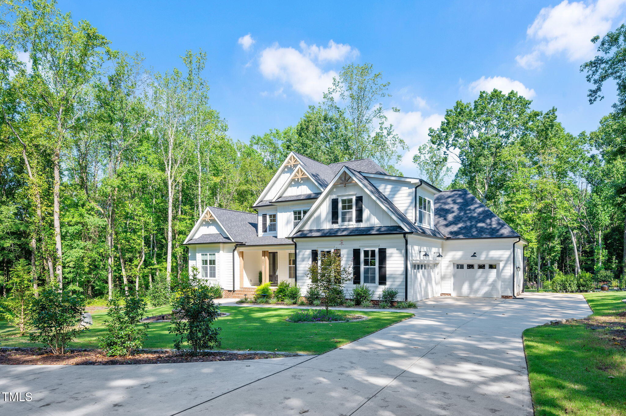 3511 Bruce Garner Road Wake Forest, NC 27587 - Photo 2 of 46 a front view of a house with a garden and trees
