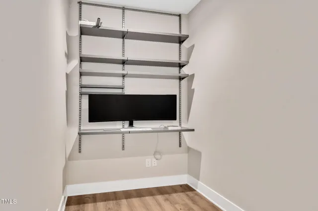 a view of a room with wooden floor and large windows