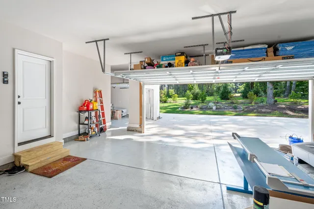 a front view of a house with a yard and potted plants