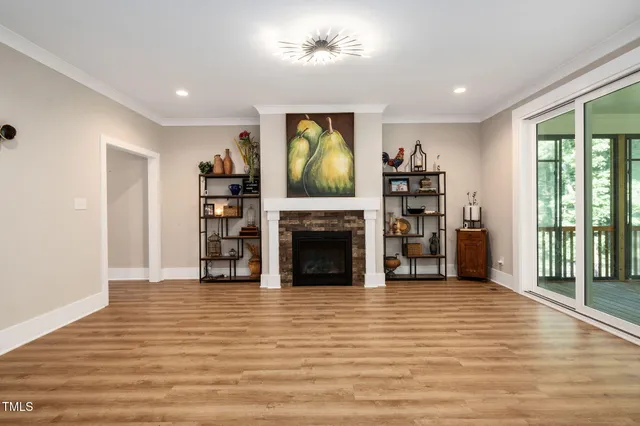 a view of a livingroom with a fireplace and a window