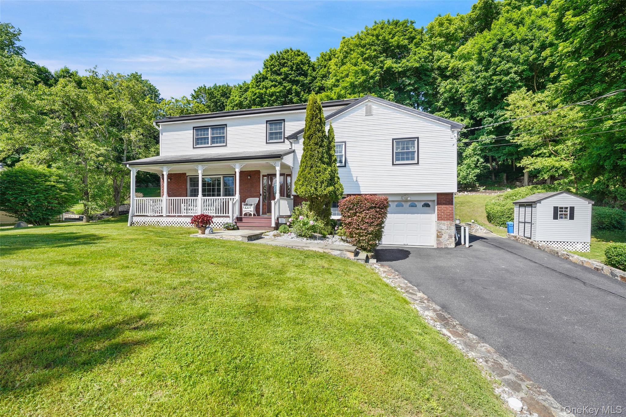 623 Cardinal Road Cortlandt Manor, NY 10567 - Photo 2 of 40 a view of a house with a backyard and a patio