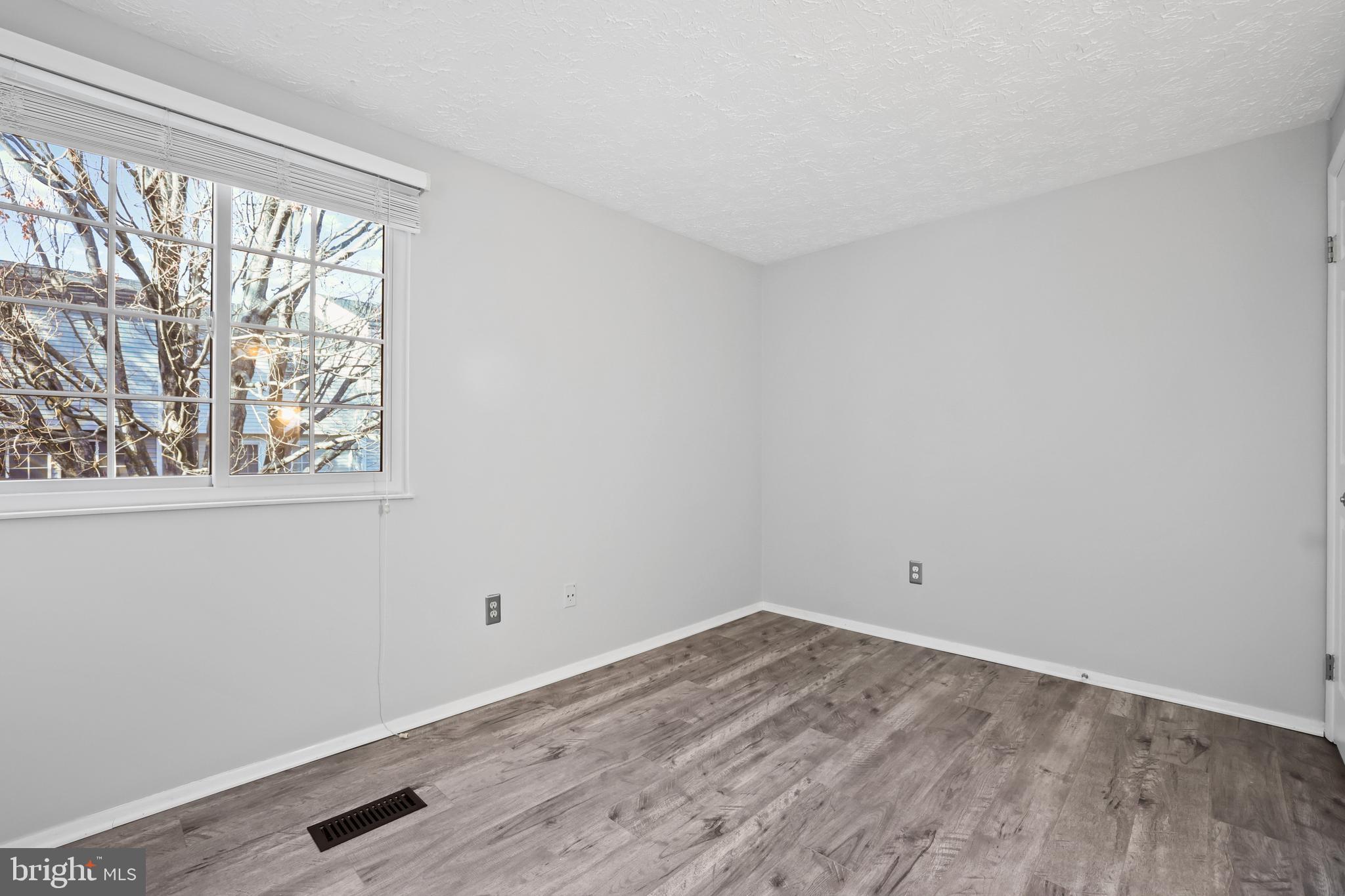 2858 New Providence Court Falls Church, VA 22042 - Photo 14 of 62 a view of a room that has a window and wooden floor