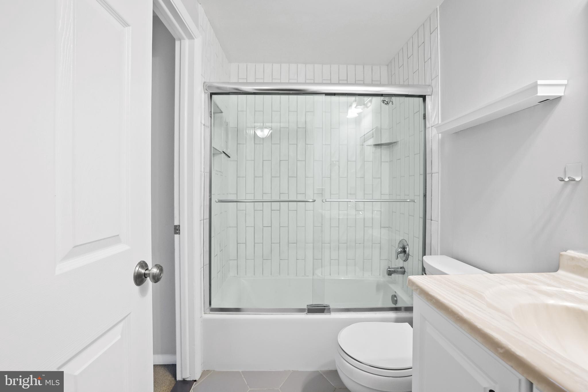 2858 New Providence Court Falls Church, VA 22042 - Photo 16 of 62 a bathroom with a shower a toilet and a sink