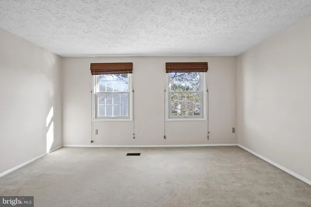 a view of empty room with wooden floor and cabinet