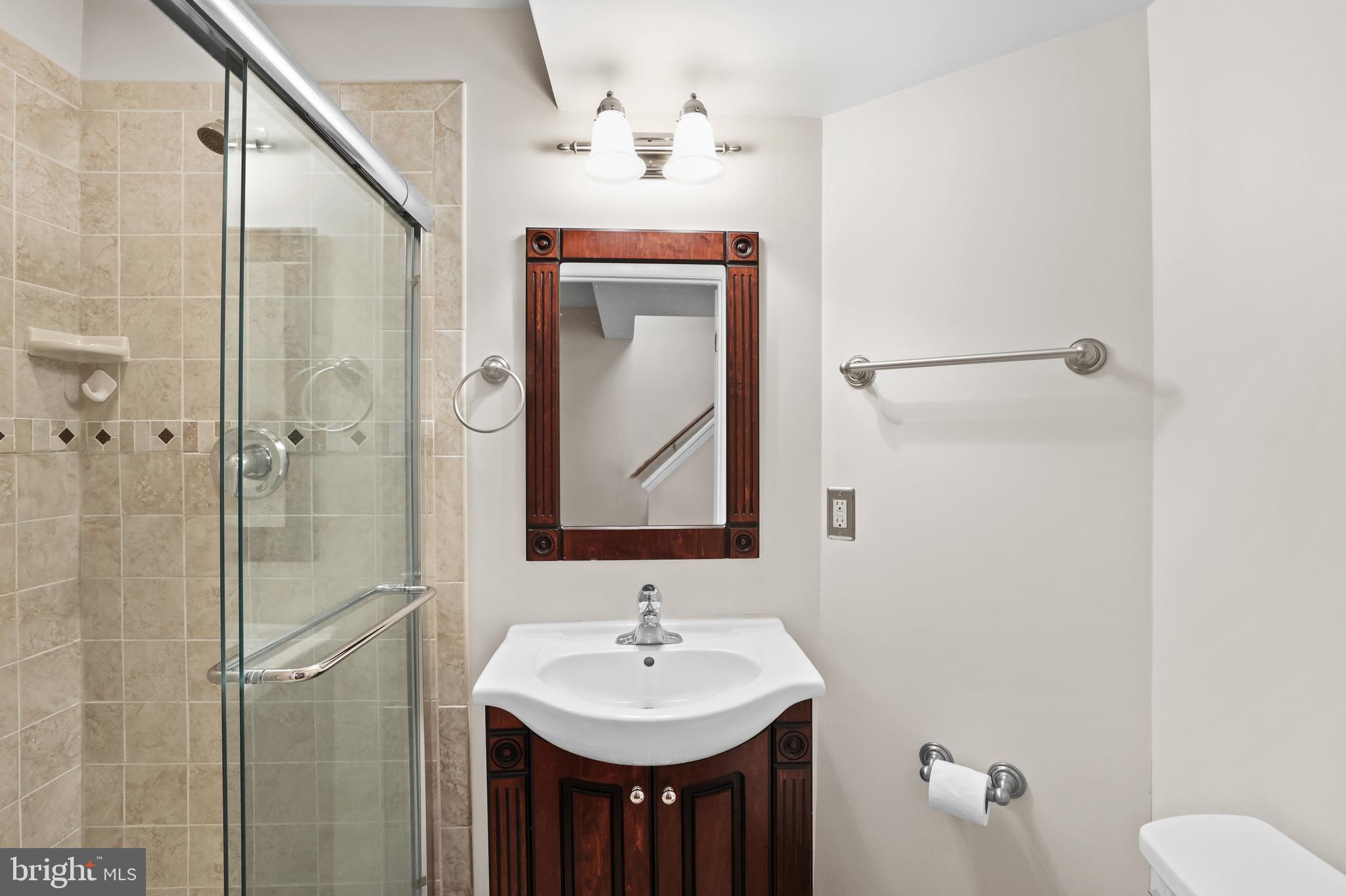 2858 New Providence Court Falls Church, VA 22042 - Photo 23 of 62 a bathroom with a sink and mirror with toilet