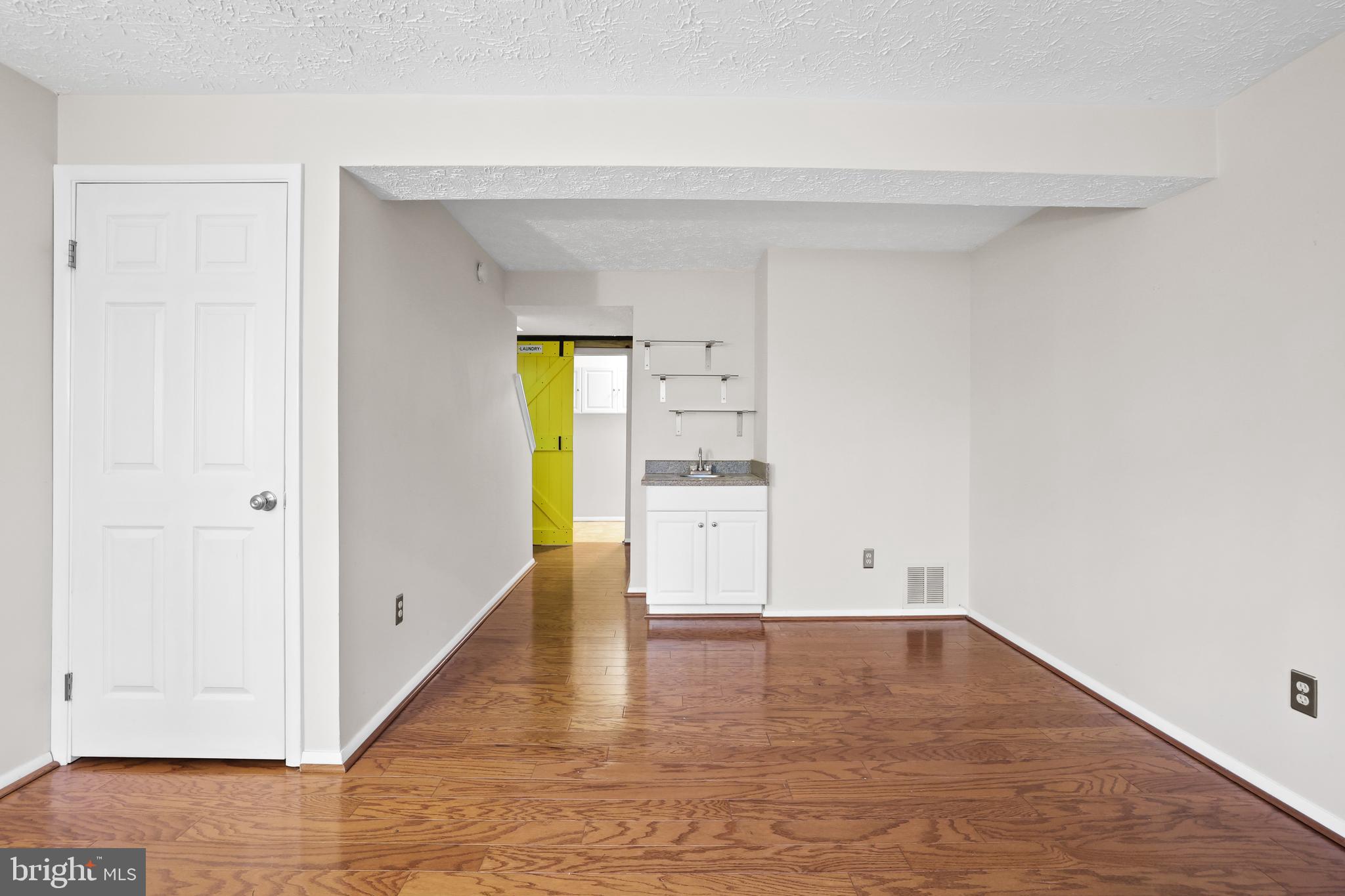 2858 New Providence Court Falls Church, VA 22042 - Photo 26 of 62 a view of empty room with wooden floor and cabinet