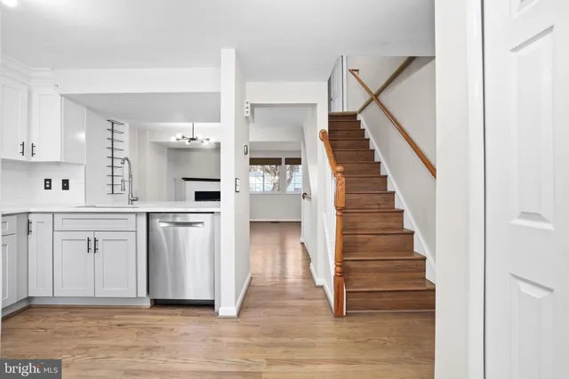 a kitchen with stainless steel appliances white cabinets white stove a microwave and a refrigerator