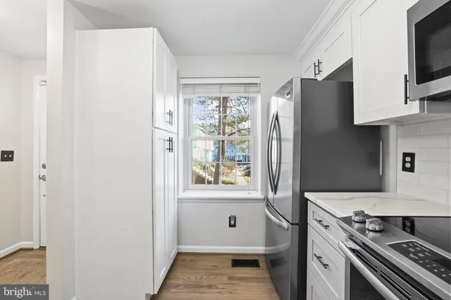 a view of an entryway with wooden floor and a cabinet
