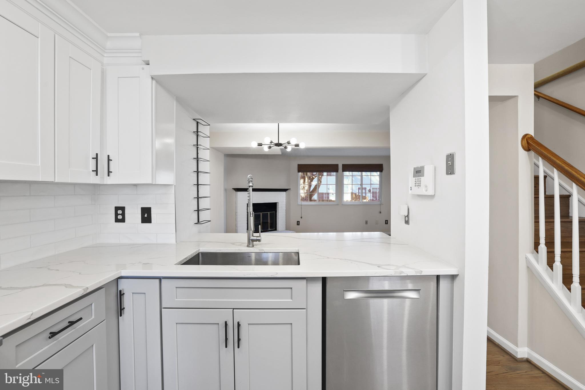 2858 New Providence Court Falls Church, VA 22042 - Photo 7 of 62 a kitchen with kitchen island granite countertop a sink cabinets and stainless steel appliances
