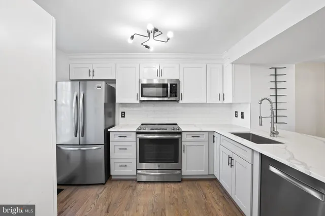 a view of an empty room with a window and fireplace