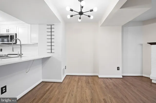 a view of a room that has a window and wooden floor