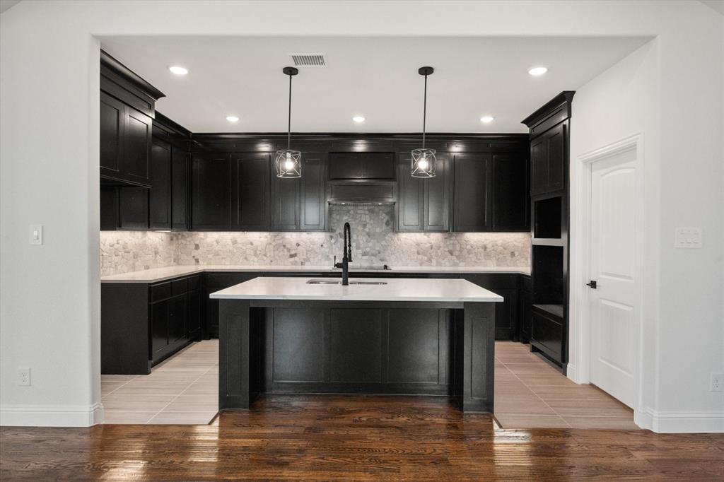 3400 Dobbins Road Corsicana, TX 75110 - Photo 9 of 40 a view of kitchen with kitchen island a sink stainless steel appliances and chairs