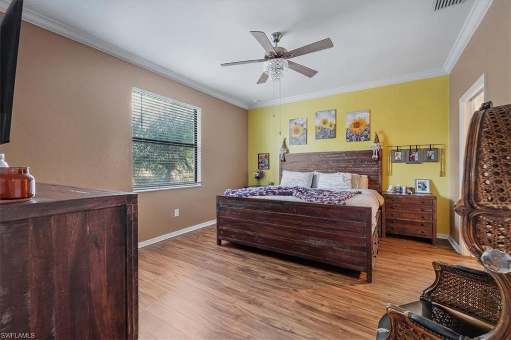 9052 Glenforest Drive Naples, FL 34120 - Photo 13 of 20 a bedroom with a bed dresser and a window